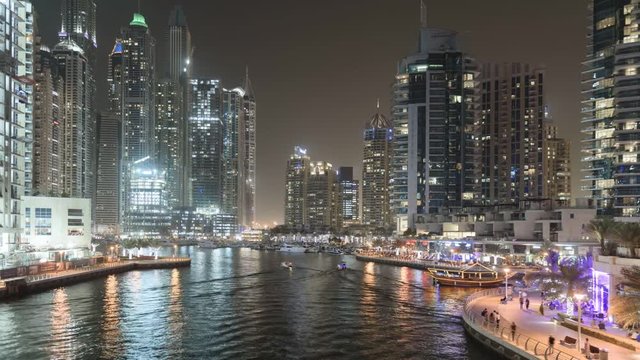 Dubai Marina with yachts in harbor and modern towers from top 