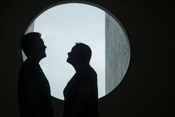 silhouette of couple lover in the window