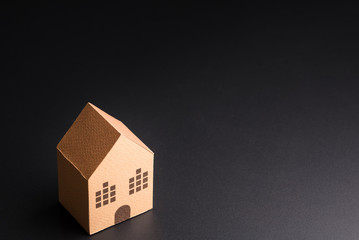 Paper house isolated on black background 