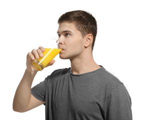 Fototapeta premium Young man drinking juice on white background