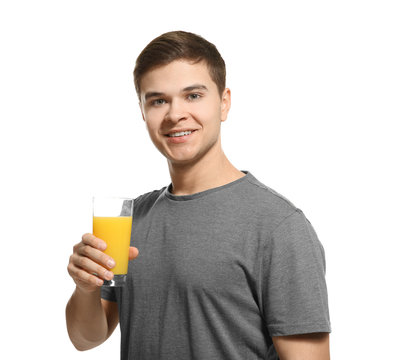 Young man drinking juice on white background