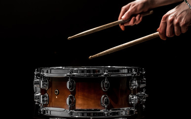 man plays musical percussion instrument with sticks a musical concept with the working drum