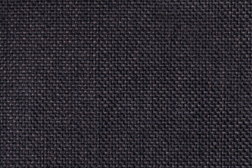 Fototapeta na wymiar Dark black textile background closeup. Structure of the fabric macro