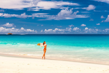 Woman with sarong on beach at Seychelles