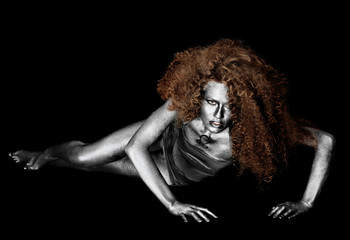 Beautiful young woman with amazing body-art as lion on dark background. Zodiac signs concept