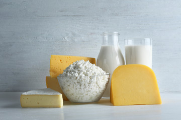 Set of fresh dairy products on light wooden background