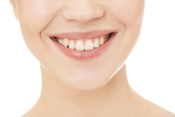 Perfect smile. Cropped close up shot of a young woman smiling isolated on white.