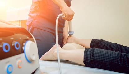 Shock wave therapy. The magnetic field, rehabilitation. Physiotherapist doctor performs surgery on...
