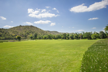 Green grass mountain view with blue sky background , Thailand.
