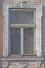 Old window on a concrete wall. Very old wooden window