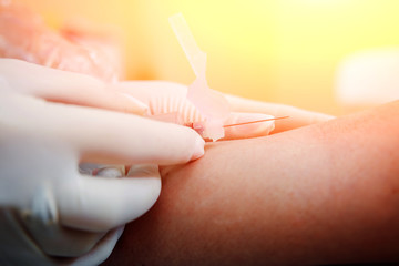 Closeup of nurse's hands taking a blood sample