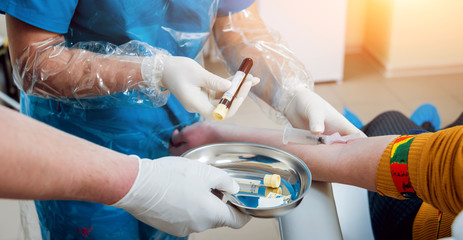 Closeup of nurse's hands taking a blood sample