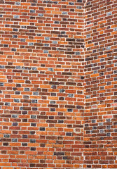 Historic brick wall with mosaic laying. Vintage red brick wall.old brick wall background. Retro red brick wall of an old historic house