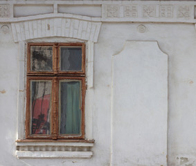 Old window on a concrete wall. Very old wooden window