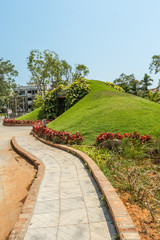Fototapeta premium Narrow view of green garden and pathway, Chennai, India, April 01 2017