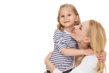 Embrace. Portrait of a loving mother hugging her little daughter at the studio on white background.