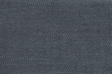 Dark blue textile background with checkered pattern, closeup. Structure of the fabric macro.