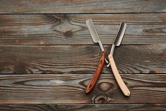 Vintage barber shop straight razor tool on wooden background