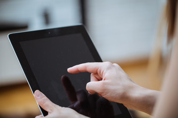 Close-up of digital tablet in a young womans hands