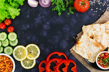 Quesadilla with chicken and corn on dark background. Top view