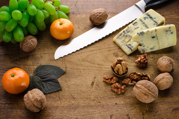 Assortment of various types of cheese on wooden board