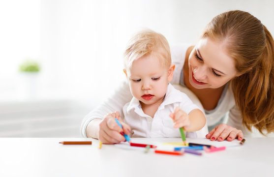 Mother with baby son with colored pencils