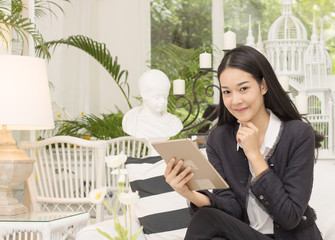 business women holding teblet in livingroom