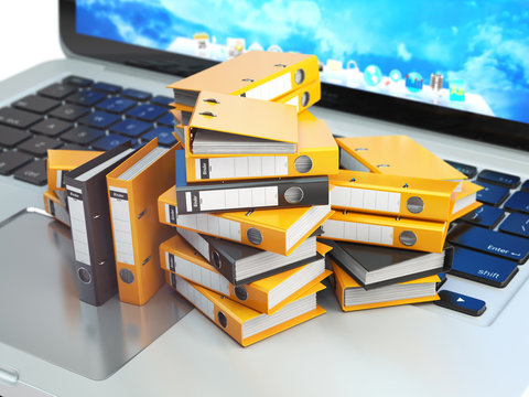 Laptop And Pile Of File Cabinet With Ring Binders. Database, Archive, Computer Data Storage, Office Paperwork And Electronic Document Management Concept.