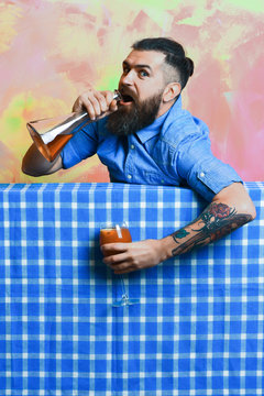 Brutal caucasian hipster with alcohol cocktail and flask