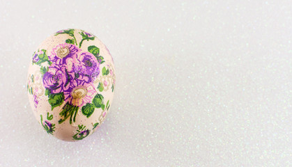 Easter egg against shiny silver background