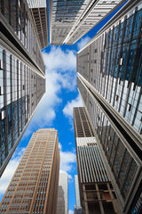Fototapeta premium Looking up at modern city buildings backgrounds