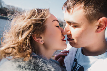 Happy couple in love hugging and sharing emotions, holding hands on the river bank