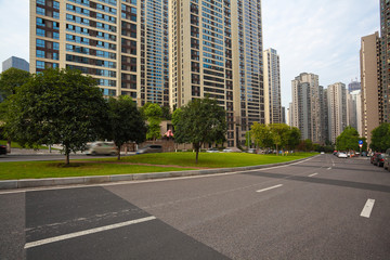 Fototapeta na wymiar Empty road surface floor with City streetscape buildings