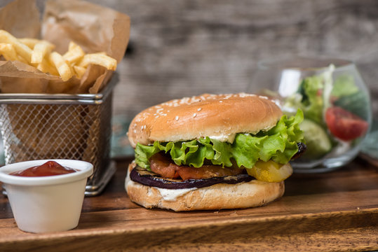 Vegetarian burger with French fries and salad