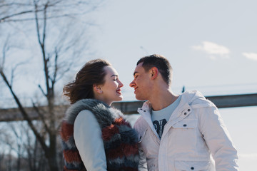 Happy couple in love hugging and sharing emotions, holding hands on the river bank