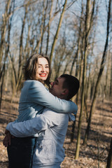 Happy couple in love hugging and sharing emotions, holding hands walking in the park