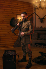 Hunter man in vintage clothing with antique rifle