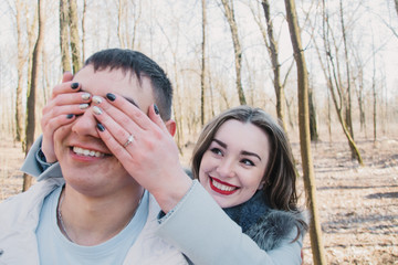 Happy couple in love hugging and sharing emotions, holding hands walking in the park