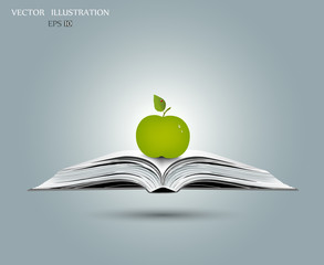 Apple on open book.