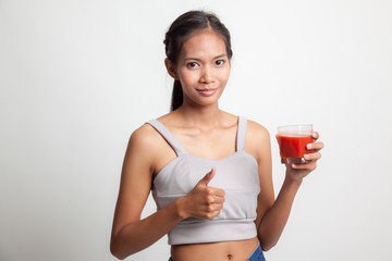 Young Asian woman thumbs up with tomato juice.