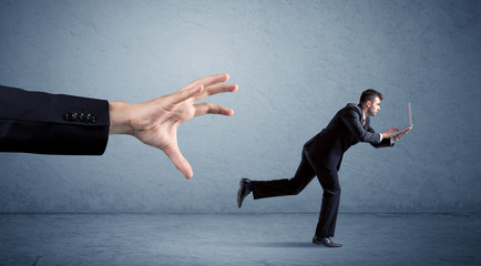 Businessman running from hand