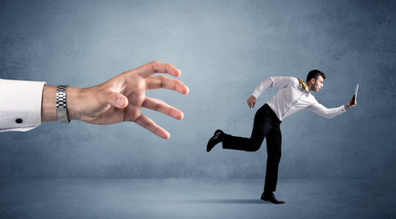 Businessman running from hand