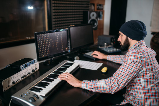 Audio engineer work with musical keyboard
