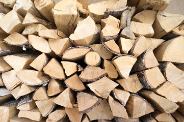 firewood for heat in the winter. Wooden logs collected neatly in a pile