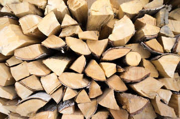 firewood for heat in the winter. Wooden logs collected neatly in a pile