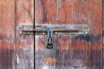old and rustic wooden door with a rusty latch