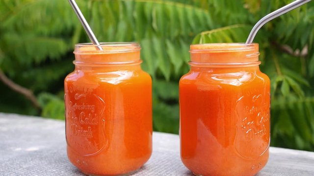 Two Glass Jars with Fresh Carrot Juice. Healthy Lifestyle