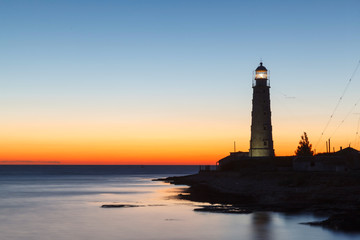 lighthouse at sunset in the twilight in clear weather