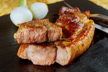 Grilled pork steak wooden dark tone background.