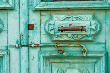 old metal handle on green door